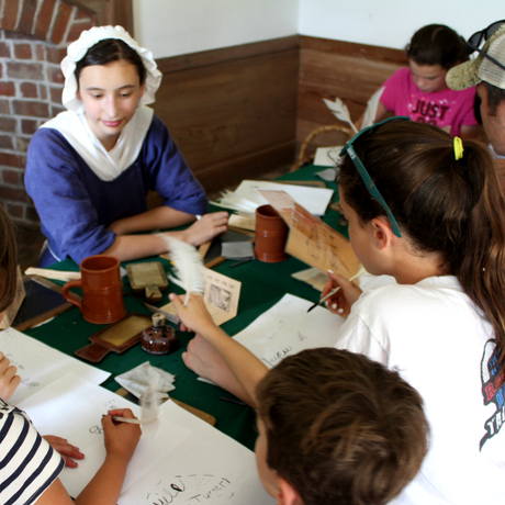 Youth Interpreter teaching quill writing